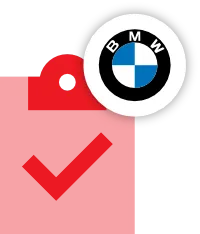 The image shows a BMW logo placed on top of a plain red price tag against a black background, evoking themes of BMW servicing or BMW repair.